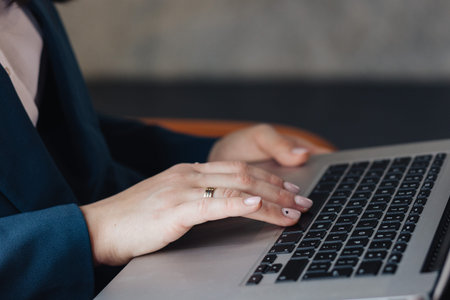 Close-up shot of hands typing on a laptop keyboard. A great choice for illustrations related to...