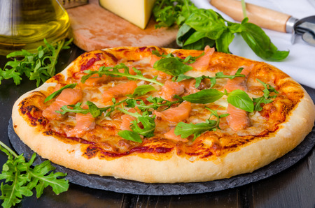 pizza with smoked salmon and arugulaの写真素材
