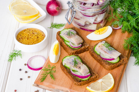 sandwich with rye bread, fresh cucumber, pickled onions, herringの写真素材
