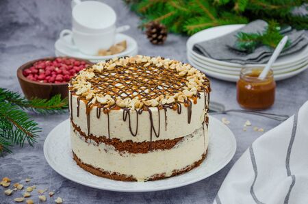 Festive layer cake with chocolate sponge cake, nougat, salted caramel and peanuts. Cake for Christmas and New Year. Horizontal orientation.の写真素材