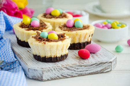 Easter mini brownie cheesecake Bird's Nest with chocolate and candy eggs. Easter dessert. Funny food...