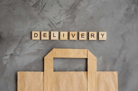 Delivery of products, foods at home. Paper bag on a dark concrete background. Horizontal orientation. Top view, copy spaceの写真素材