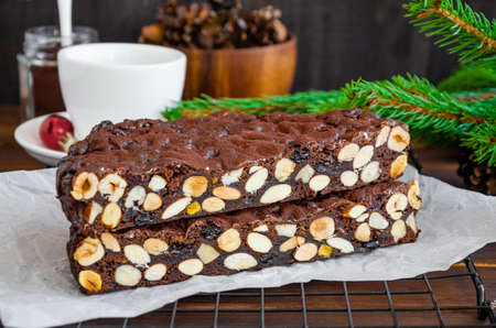 Panforte. Traditional Italian Christmas dessert with nuts and dried fruit on a dark wooden background. Horizontal, copy spaceの写真素材