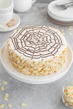 Traditional Esterhazy cake with almonds and pralines on a gray concrete background. Selective focus....