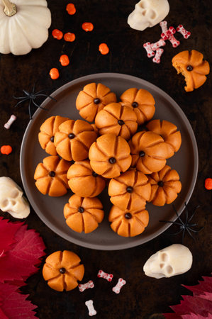 Halloween spicy mini cheesecakes with pumpkin puree in the form of small pumpkins. Halloween or...