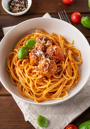 Traditional Italian spaghetti pasta with meatballs, tomato sauce and parmesan cheese, selective focus. Comfort foodの写真素材