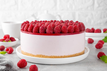No baked raspberry cheesecake or raspberry cream mousse cake with jelly and fresh berries on top on...