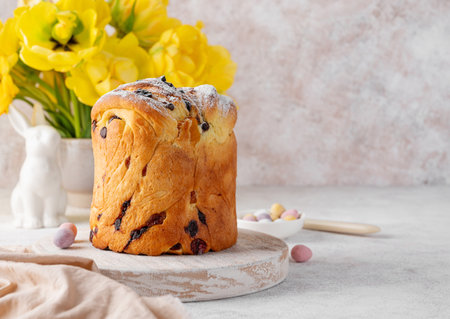 Easter composition. Traditional Easter bread - Paska, Cruffin, Kraffin or Kulich with chocolate and candied fruits on a concrete background. Selective focusの写真素材