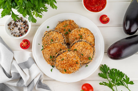 Baked garlic crispy eggplant with tomato sauce on a plate. Vegetarian food. Selective focus, top viewの写真素材