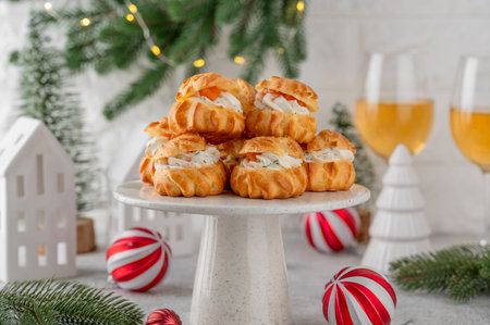 Profiteroles with smoked salmon, cream cheese and dill on a concrete background. Appetizer for Christmas and New Year. Selective focus, copy spaceの写真素材
