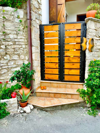 tourist view. View of a wooden door in the tourist Cypriot mountain village of Lanja. The craft of making wooden shoes.の写真素材