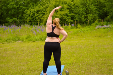 Portrait of happiness plus size woman practicing yoga on outdoors.Yoga and relax concept.