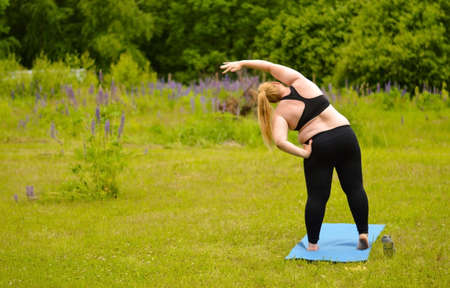 Portrait of happiness plus size woman practicing yoga on outdoors.Yoga and relax concept.の写真素材
