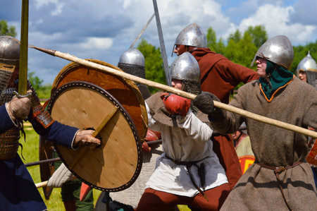Pskov, Russia, July 10. 2022. Historical Reenactment. Epic Invading Army of Medieval Knights on Battlefield, Plate Body Armored Soldiers with Swords in Battle Cry. War and Conquest.のeditorial素材