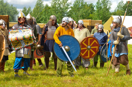 Pskov, Russia, July 10. 2022. Historical Reenactment. Epic Invading Army of Medieval Knights on Battlefield, Plate Body Armored Soldiers with Swords in Battle Cry. War and Conquest.のeditorial素材