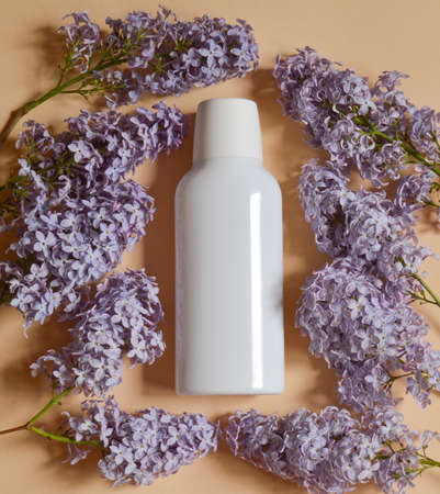 Empty white packaging tube for beauty spa, medical skin care and cosmetic lotion cream packaging, face wash foam, product design layout on beige backgroundの写真素材