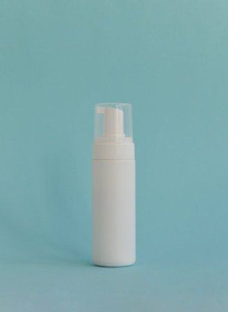 Empty white packaging tube for beauty spa, medical skin care and cosmetic lotion cream packaging, face wash foam, product design layout on blue backgroundの写真素材
