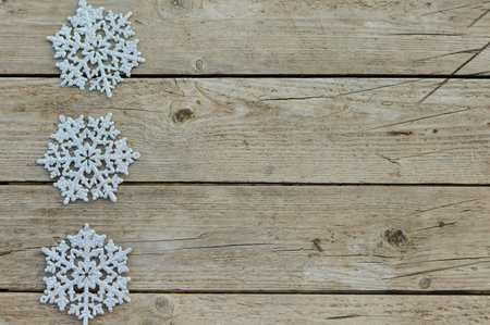 Christmas decorative silvery snowfields on a rustic wooden background. Waiting for the holiday, a...