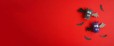 Banner DIY flat layout of toys made by children, Halloween decorations on a red background. Space...