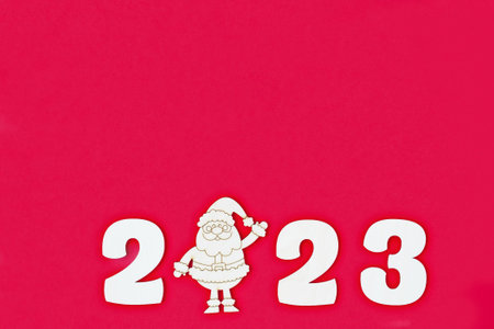 Happy New year 2023 number wood object on red background and copy space - red color new year...