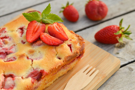 Delicious summer dessert strawberry pie, sweet homemade holiday cake decorated with mint leaves on a...