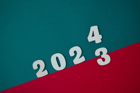 From 2023 to 2024 wooden numbers on a red and green background. mid year conceptの写真素材