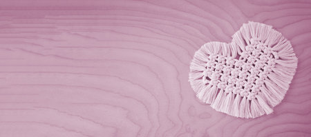 Macrame handmade napkin in the form of heart. Eco diy home decoration. Natural materials, cotton thread. St. Valentine's Day. tinted imageの写真素材