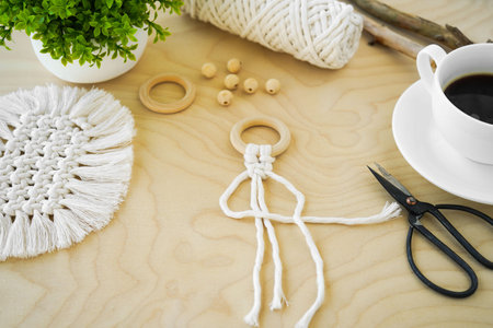 close-up Macrame handmade Hobby. Flat lay Cup of coffee on wooden serving tray with macrame...
