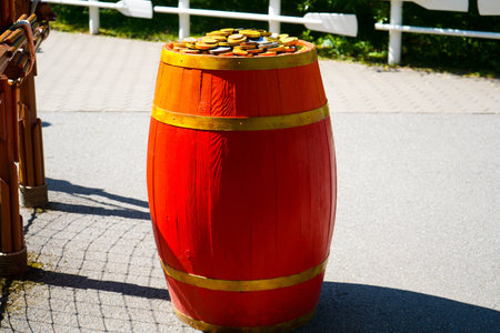Red wooden barrel with gold coins in the park on a sunny summer dayの写真素材