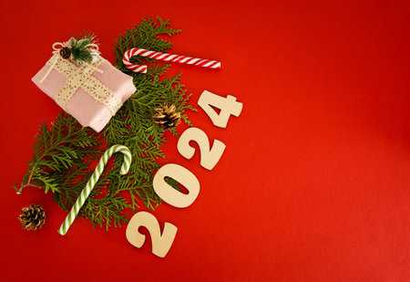 Christmas frame with a Christmas tree and gifts on a green background. Winter holidays. Space for text. Top view, flat lay. Christmas. Template, layout. A greeting card with numbers 2024の写真素材