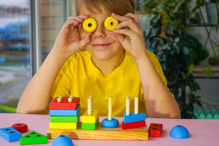 eco wooden toys. The child collects a sorter. Educational logic toys for kids. Games for Child...