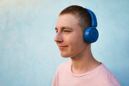 Portrait of a young guy with headphones. Teenage skin problems, acne. lifestyle concept