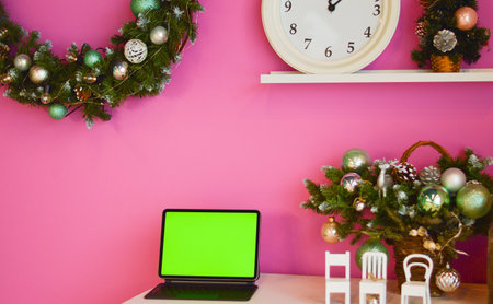 Working from cafe during Christmas holidays. A computer with a mockup green screen. Customer service. No peopleの写真素材