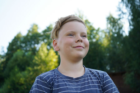 Portrait of a smiling boy on the streetの写真素材