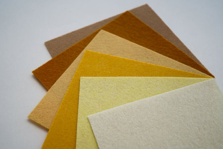 Different shades of beige felt folded vertically on top of each other.の写真素材