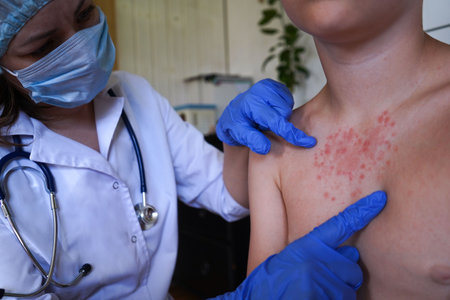 The physician is inspecting the boy's skin for health issues.の写真素材