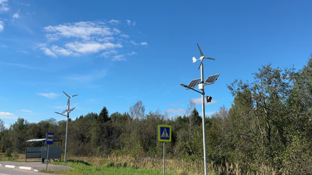 windmills and solar panels on the side of the country road