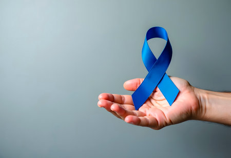 November Prostate Cancer Awareness month, adult Man holding light Blue Ribbon with mustache for supporting people living and illness. Healthcare, International men, Father and World cancer day conceptの素材