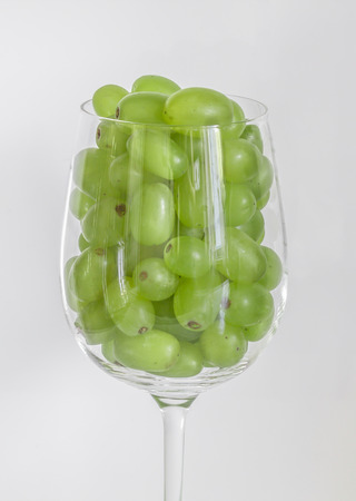 grapes in a glass of wineの写真素材