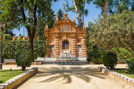 Beautiful fontain in the Alcazar fortress wall. Alley Catalina de Ribera, Seville, Spain