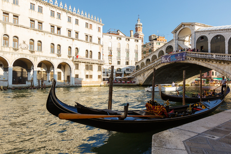 View of gondola and Ponte di Rialto, many tourists on a bridge. Sunset in Veniceのeditorial素材