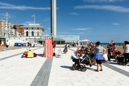 People are watching a performance of a puppet theater in Brighton, i360 towerのeditorial素材