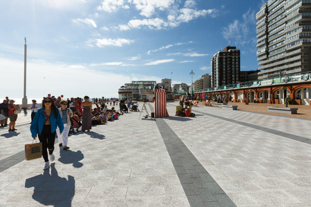 People are watching a performance of a puppet theater in Brighton, beach chairsのeditorial素材