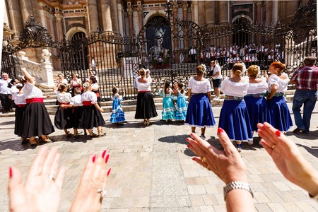Women dance flamenko near Malaga Cathedral on city holiday of Holy Virgin Maryのeditorial素材