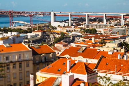 many bright tiled roofs of Lisbon, 25 th April Bridge connecting to of Almadaの写真素材