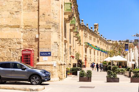 Street signboard Balzunetta near the british red phone box, limestone wallのeditorial素材