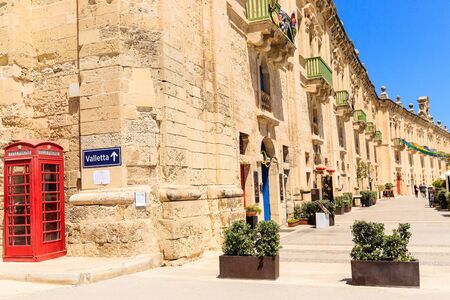 Street signboard Balzunetta near the british red phone box, limestone wallのeditorial素材
