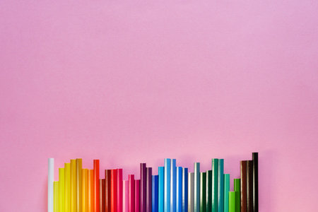 Color pencils in a row on yellow background. Education, school concept. Seamless colored pensils...