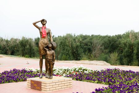 Monument of Mother and little son in fathers pilot cap are looking at the sky.のeditorial素材