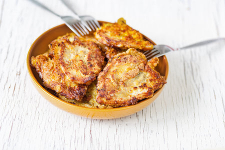 Chicken fried in batter with dill on a plate